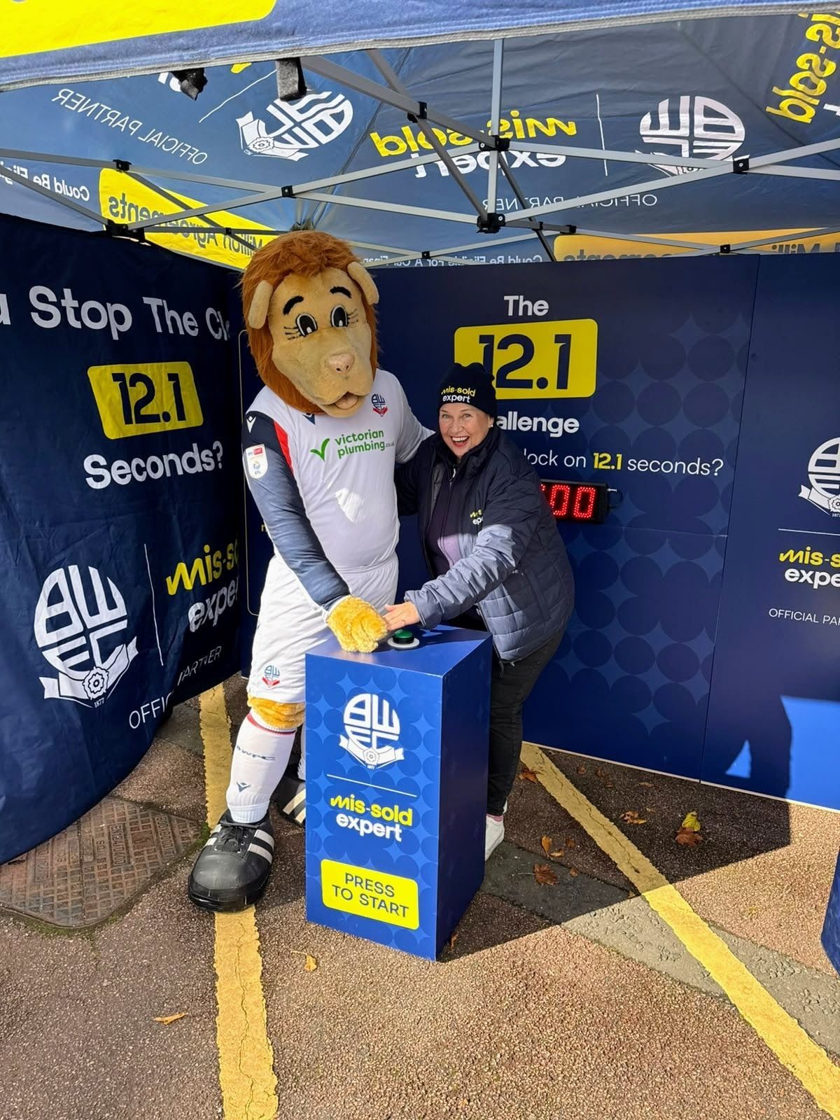 Bolton Wanderers mascot taking on The 12.1 Challenge with a Mis-Sold Expert brand ambassador