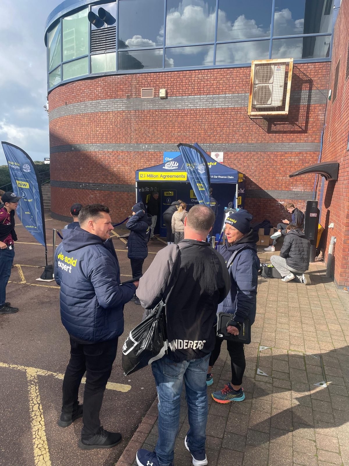 Mis-Sold Expert matchday team talking to fans beside the activation stand at Bolton Wanderers