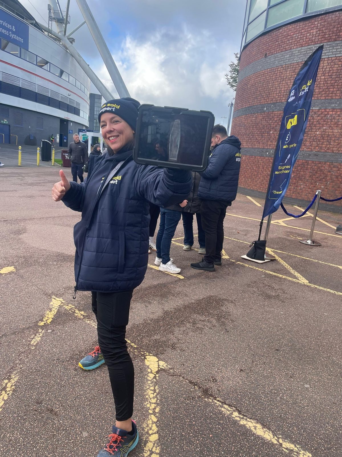 Roaming Mis-Sold Expert brand ambassador with an iPad on the stadium forecourt