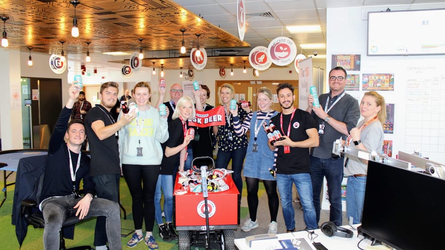 EXECUTIONAL sampling team with Camden Town Brewery desk beers in an open-plan office