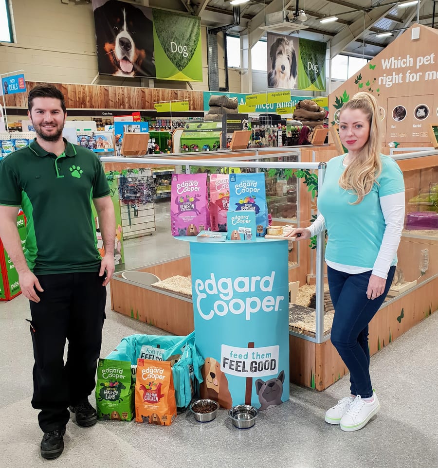 EXECUTIONAL team member beside a new Edgard and Cooper line in a pet store