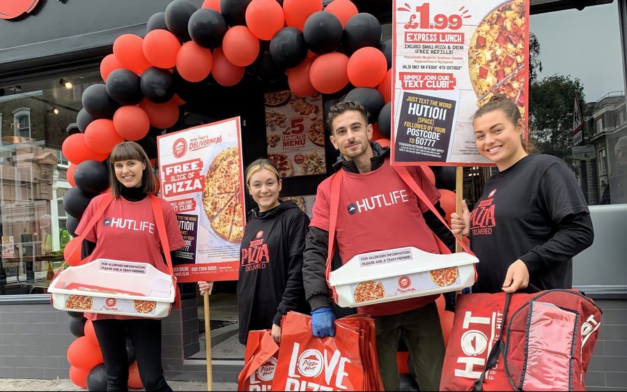 Restaurant team outside a Pizza Hut on opening day