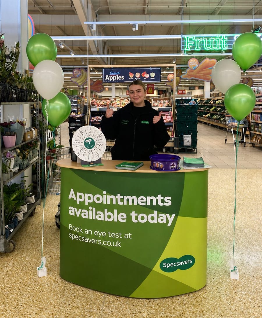 EXECUTIONAL team member at an in-store stand inside a supermarket