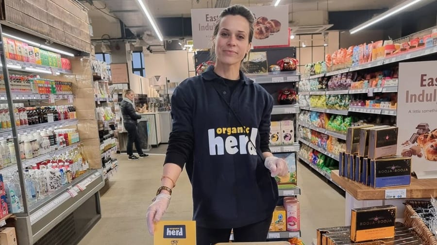 EXECUTIONAL promotional staff for Organic Herd working the chiller aisle in a Planet Organic store