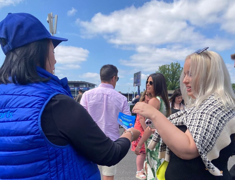 EXECUTIONAL race day team member talking to racegoers for BoyleSports at Newbury Racecourse