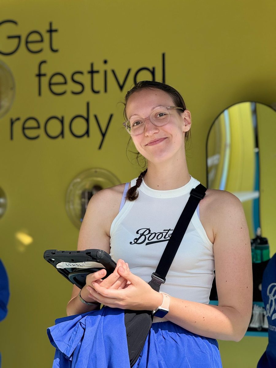 EXECUTIONAL festival staff member with a tablet at the Boots space, Latitude Festival