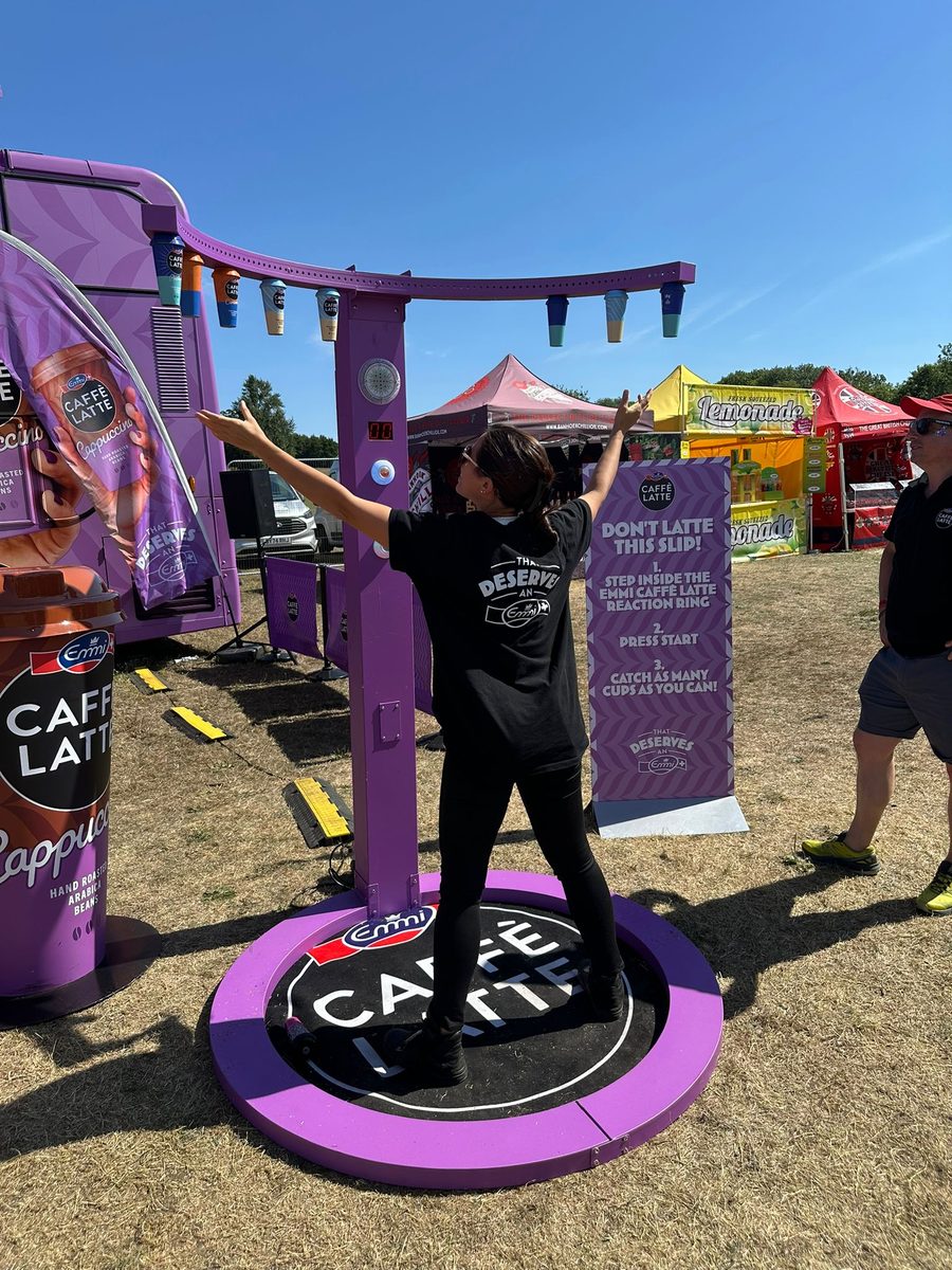 EXECUTIONAL sampling team on an open-air Emmi Caffè Latte site with deckchairs on the grass
