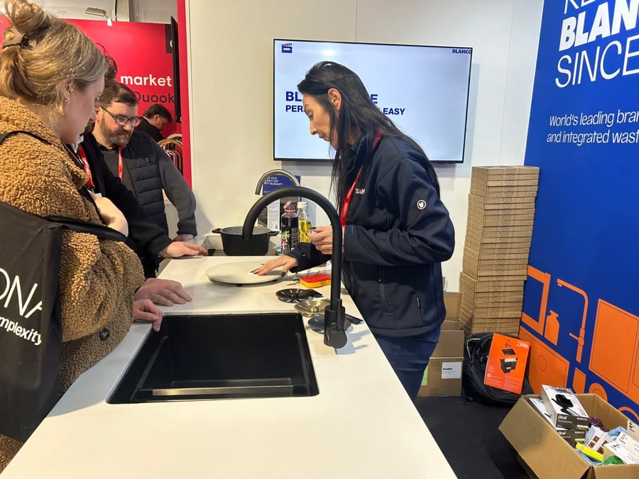 EXECUTIONAL demonstration staff showing a BLANCO sink to visitors at the Howdens Expo