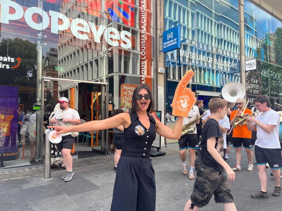 EXECUTIONAL brand ambassador leading fans at the Popeyes World Cup fan zone on Tottenham Court Road in London